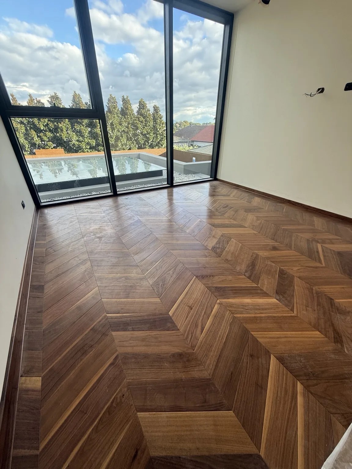 Chevron timber floor with full height glazing